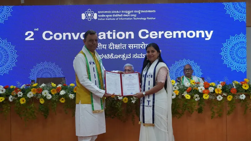 A graduate receiving her degree certificate on stage at the 2nd Convocation